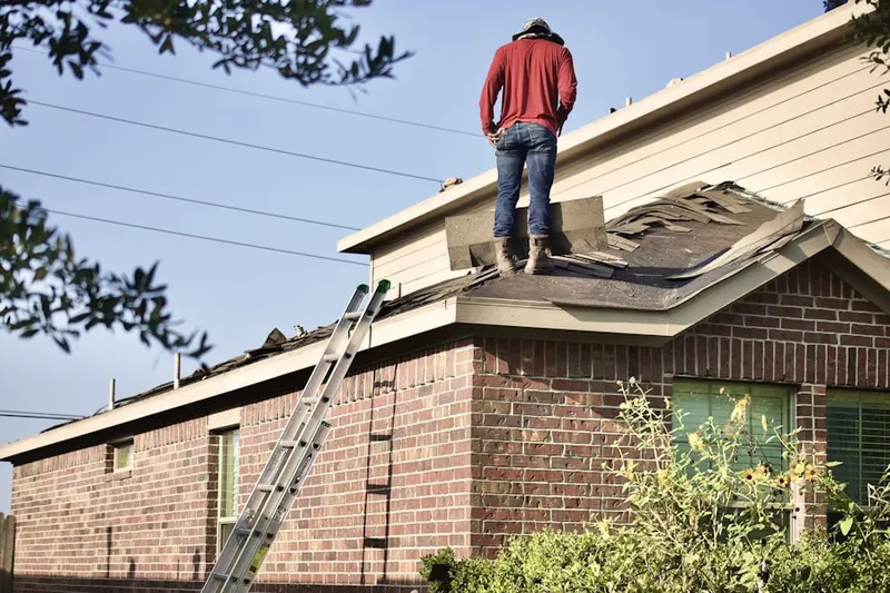 Professional roofer working on a residential roof in Eberlys Mill